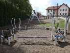 Plac zabaw w Brzączowicach zyskał nowe atrakcje dla dzieci mini park linowy zamontowany na placu zabaw w tle budynek szkoły podstawowej w Brzączowicach