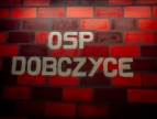 Napis Osp Dobczyce na czerwonej kostce na ścianie 
